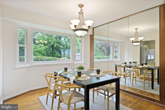 3702 Forest Grove Dr, Annandale, VA 22003 - dining area with a chandelier, baseboards, and wood finished floors