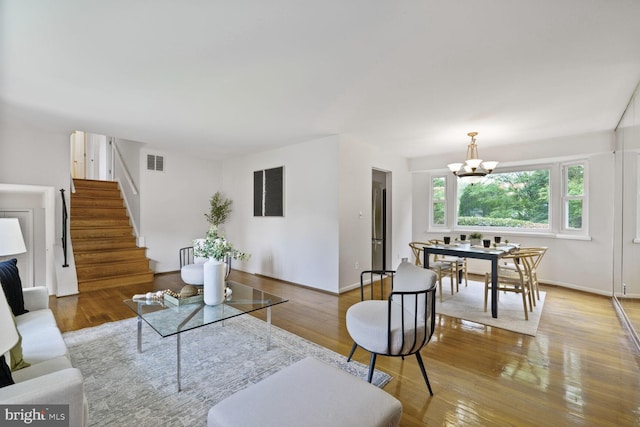 3702 Forest Grove Dr, Annandale, VA 22003 - living room with a chandelier, stairs, wood finished floors, and baseboards