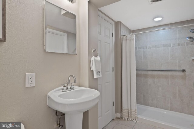 3702 Forest Grove Dr, Annandale, VA 22003 - full bathroom with tile patterned flooring, tiled shower, and a sink