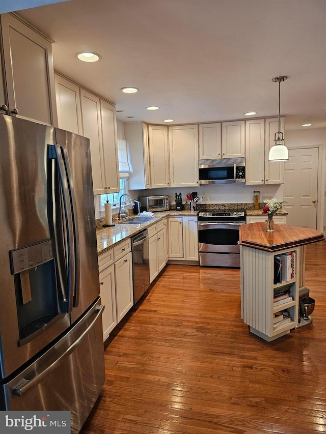 24749 Swan Rd, Saint Michaels, MD 21663 - kitchen featuring stainless steel appliances, wood counters, a sink, recessed lighting, and hardwood / wood-style flooring