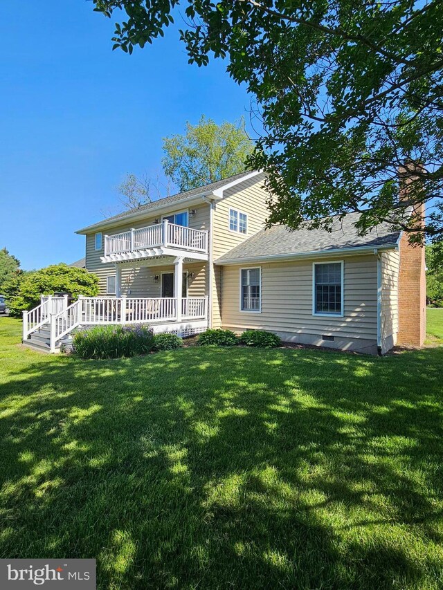 24749 Swan Rd, Saint Michaels, MD 21663 - back of property featuring a balcony, a lawn, and a chimney