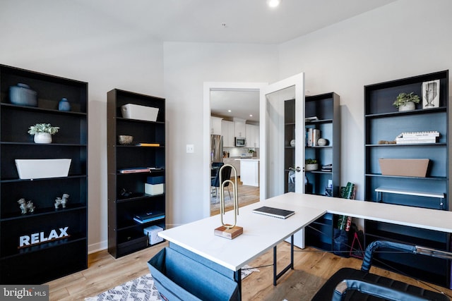 home office with light wood-style flooring