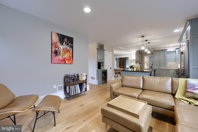 living area with light wood finished floors, baseboards, and recessed lighting