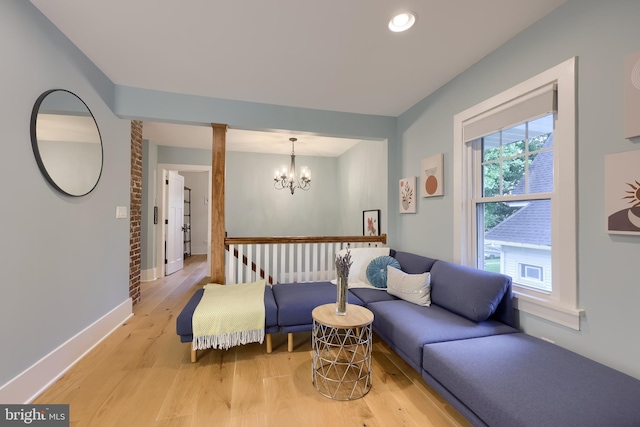 living room with a chandelier, light wood-style flooring, baseboards, and recessed lighting