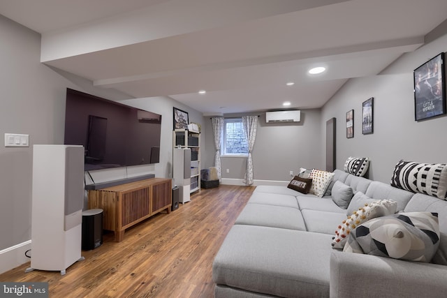 living area with a wall unit AC, light wood-style flooring, baseboards, and recessed lighting