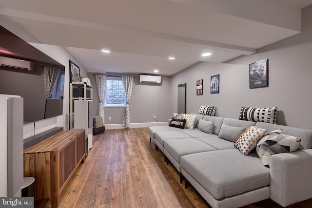 living room with a wall mounted air conditioner, baseboards, wood finished floors, and recessed lighting