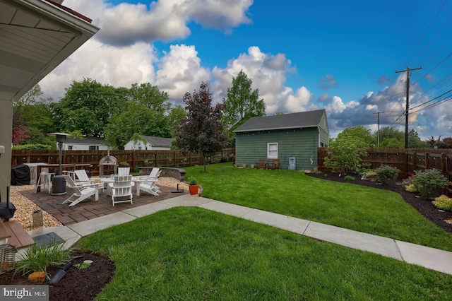 view of yard featuring a patio and an outbuilding