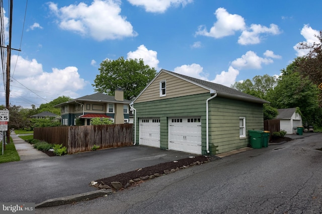 view of front facade with fence and a garage