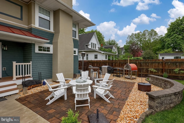 view of patio / terrace with fence and a grill