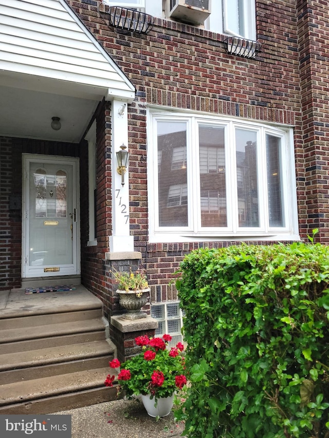 property entrance with brick siding