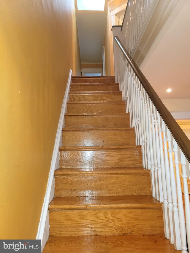 staircase with wood finished floors