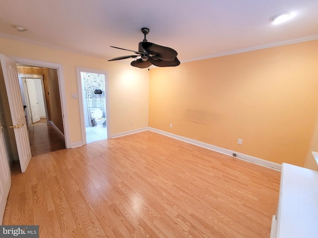 empty room with a ceiling fan, crown molding, light wood finished floors, and baseboards