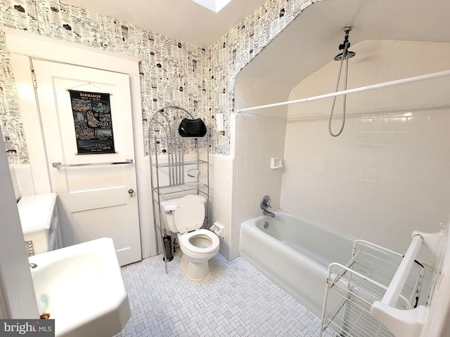 bathroom with toilet, a sink, and  shower combination