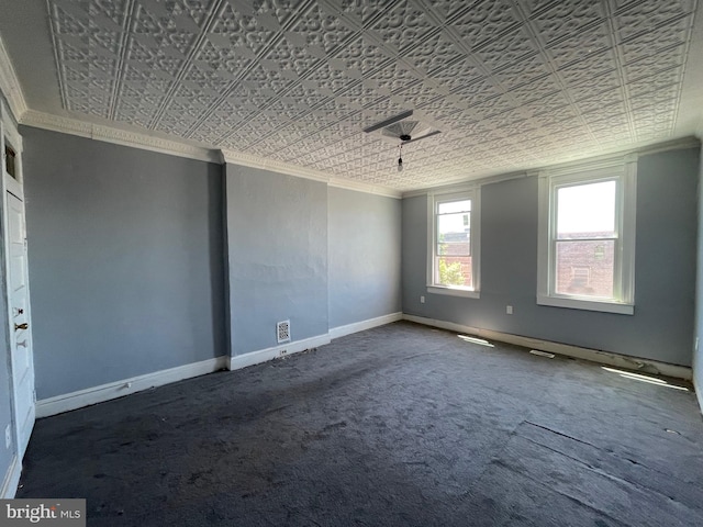 empty room featuring ornamental molding, an ornate ceiling, carpet, and baseboards