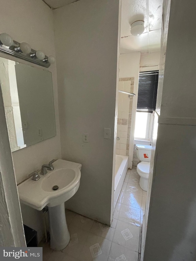 full bath featuring a shower, tile patterned flooring, and toilet