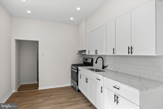 1294 Chase St, Camden, NJ 08104 - kitchen with stainless steel gas range, a sink, baseboards, light stone counters, and light wood finished floors