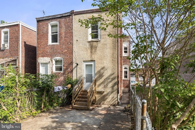 1294 Chase St, Camden, NJ 08104 - view of front of house featuring entry steps, brick siding, and stucco siding