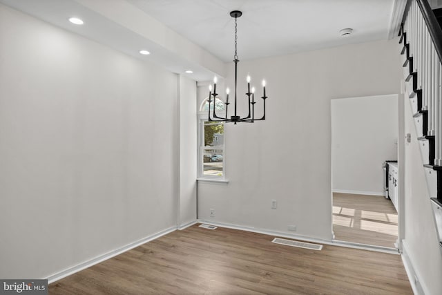 1294 Chase St, Camden, NJ 08104 - unfurnished dining area with wood finished floors, a chandelier, recessed lighting, and baseboards