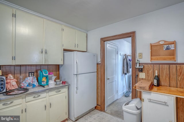 85 Woodland Ave, Ocean View, DE 19970 - kitchen with freestanding refrigerator, light countertops, light floors, and a wainscoted wall