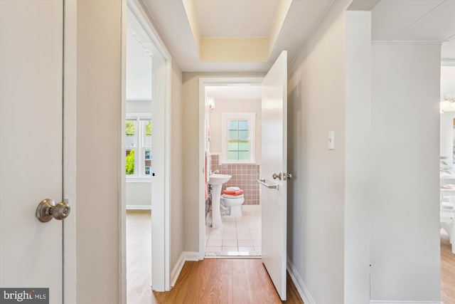 6624 Boulevard Vw Unit C1, Alexandria, VA 22307 - hall featuring light wood-style flooring, tile walls, and a sink