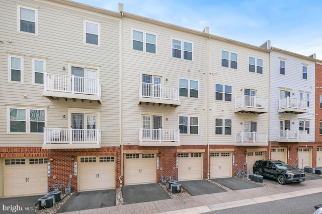 232 Urban Ave Unit 232, Gaithersburg, MD 20878 - view of building exterior featuring driveway, an attached garage, and central AC