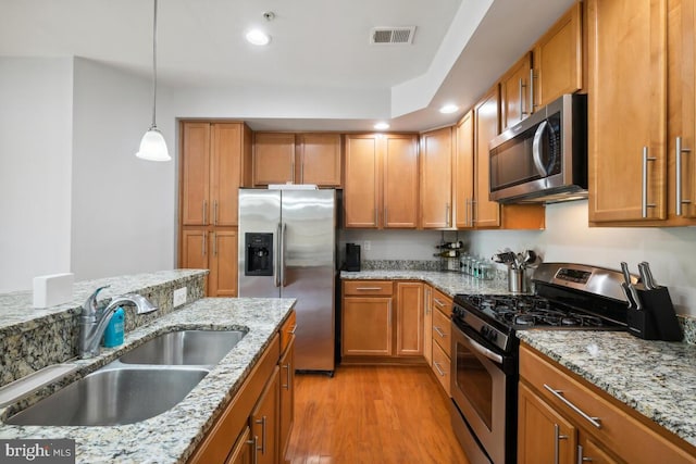 232 Urban Ave Unit 232, Gaithersburg, MD 20878 - kitchen featuring stainless steel appliances, a sink, brown cabinets, recessed lighting, and pendant lighting