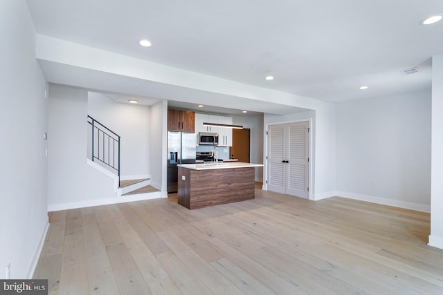 845 19th St NE Unit Ph-12, Washington, DC 20002 - kitchen featuring appliances with stainless steel finishes, light wood finished floors, baseboards, light countertops, and recessed lighting