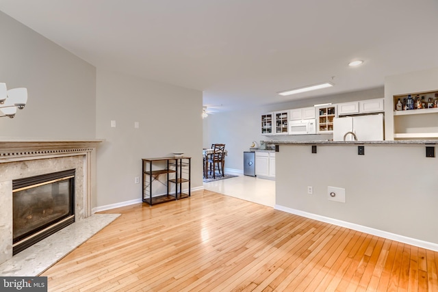 2212 Palustris Ln, Abingdon, MD 21009 - living area featuring light wood-style flooring, a fireplace, baseboards, a ceiling fan, and recessed lighting