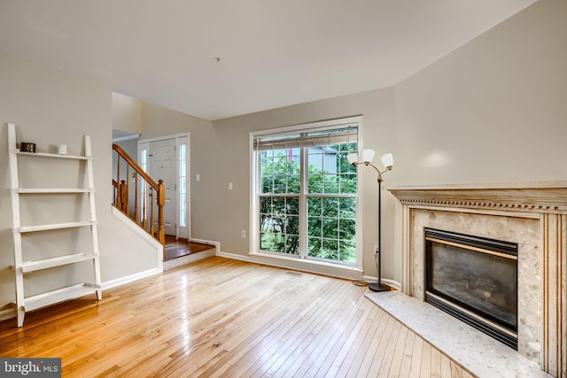 2212 Palustris Ln, Abingdon, MD 21009 - unfurnished living room with wood-type flooring, stairs, baseboards, and a premium fireplace