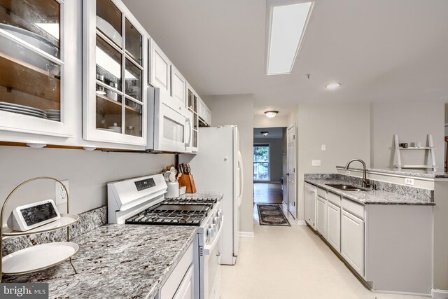 2212 Palustris Ln, Abingdon, MD 21009 - kitchen with white appliances, a sink, glass insert cabinets, light stone counters, and white cabinets
