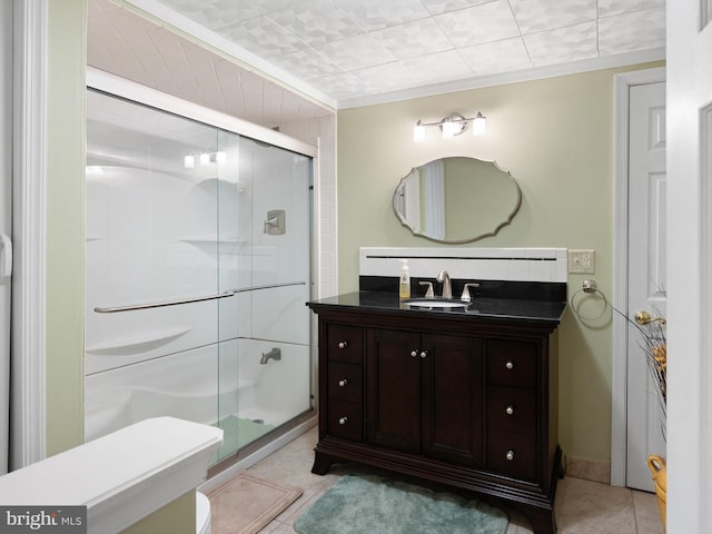 35553 Dry Brook Dr, Rehoboth Beach, DE 19971 - bathroom featuring a stall shower, toilet, vanity, tile patterned floors, and ornamental molding
