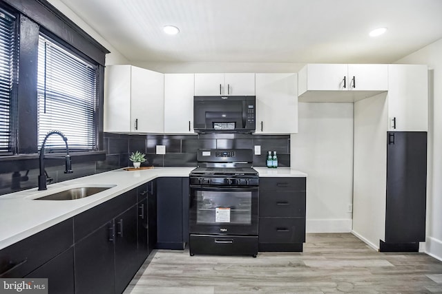 24 Cuthbert Rd, Cinnaminson, NJ 08077 - kitchen with black appliances, a sink, light countertops, white cabinetry, and recessed lighting