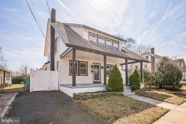 24 Cuthbert Rd, Cinnaminson, NJ 08077 - view of front of house with a porch, a gate, fence, driveway, and roof with shingles