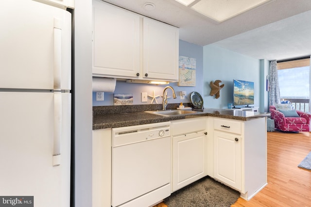 9900 Coastal Hwy Unit 1903, Ocean City, MD 21842 - kitchen with white appliances, a sink, light wood-type flooring, dark countertops, and expansive windows