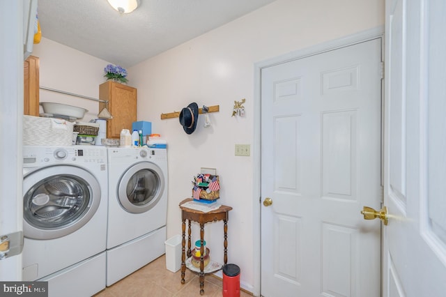 523 Zig Zag Ln, Inwood, WV 25428 - laundry room featuring cabinet space, separate washer and dryer, light tile patterned flooring, and a textured ceiling