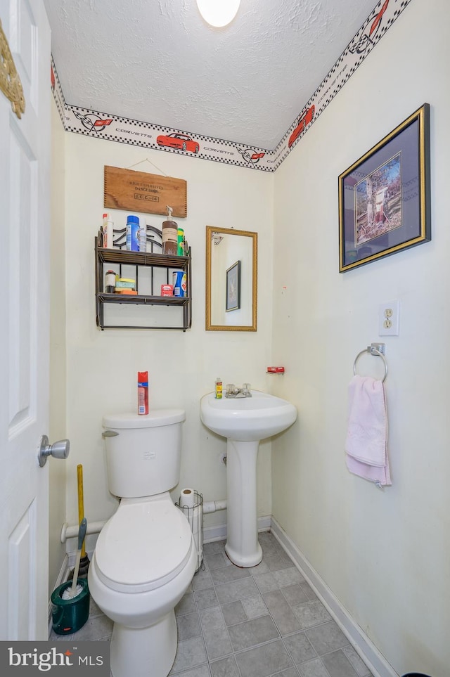 523 Zig Zag Ln, Inwood, WV 25428 - half bathroom with baseboards, a textured ceiling, toilet, and a sink