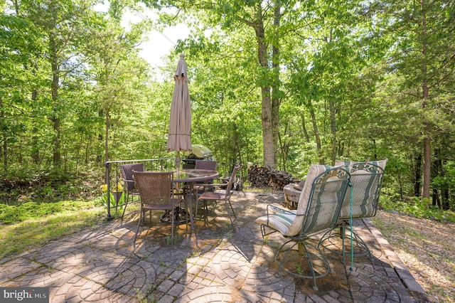 523 Zig Zag Ln, Inwood, WV 25428 - view of patio / terrace featuring outdoor dining area and a wooded view