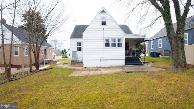 rear view of property featuring a yard and a patio