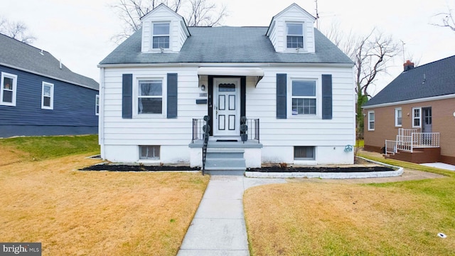 cape cod-style house with a front lawn