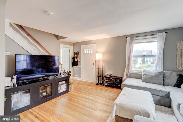 living room featuring wood finished floors and stairs