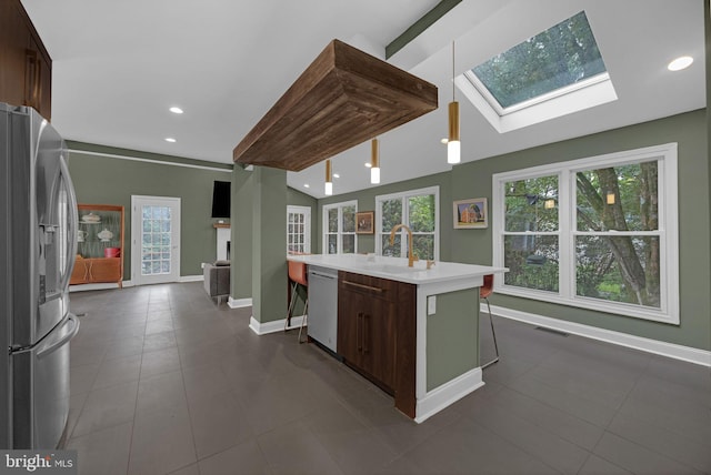 329 Dickinson Ave, Swarthmore, PA 19081 - kitchen with appliances with stainless steel finishes, a sink, light countertops, a skylight, and baseboards