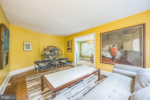 329 Dickinson Ave, Swarthmore, PA 19081 - living room featuring baseboards, wood finished floors, and a chandelier