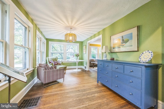 329 Dickinson Ave, Swarthmore, PA 19081 - sitting room featuring wood finished floors, baseboards, and a chandelier