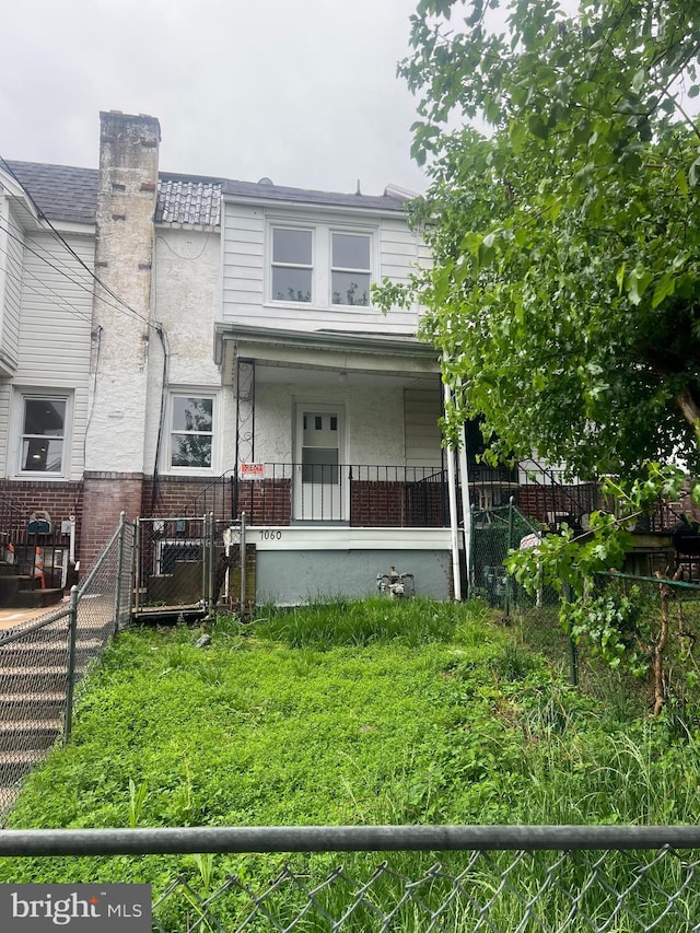 view of front of home featuring brick siding and covered porch
