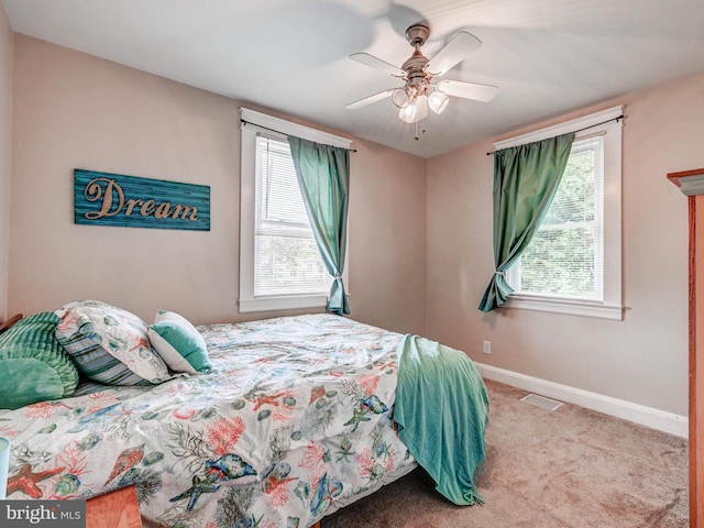 3932 Glenhurst Rd, Baltimore, MD 21222 - carpeted bedroom featuring multiple windows, baseboards, and a ceiling fan