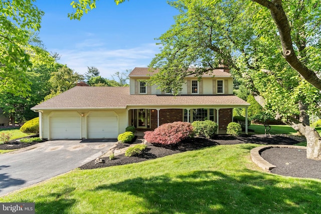 60 S Forge Manor Dr, Phoenixville, PA 19460 - traditional-style home featuring asphalt driveway, an attached garage, a front yard, brick siding, and a chimney