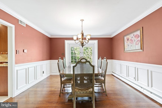 60 S Forge Manor Dr, Phoenixville, PA 19460 - dining space with a chandelier, a baseboard radiator, a wainscoted wall, crown molding, and wood finished floors