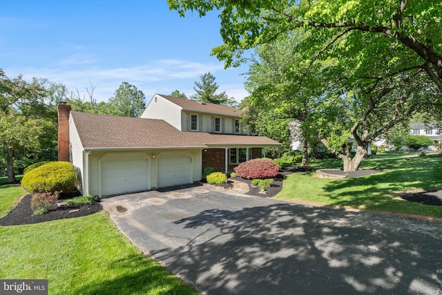 60 S Forge Manor Dr, Phoenixville, PA 19460 - traditional-style home with asphalt driveway, a garage, a chimney, a front yard, and a shingled roof