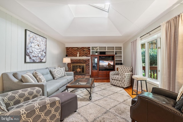 60 S Forge Manor Dr, Phoenixville, PA 19460 - living room featuring wood finished floors, a tray ceiling, a brick fireplace, built in features, and a skylight