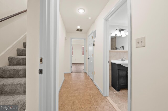 901 W Barre St, Baltimore, MD 21230 - hallway with stairway, light tile patterned floors, baseboards, recessed lighting, and a sink